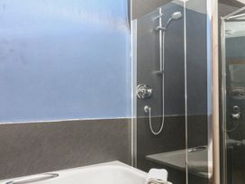 A bathroom with a bathtub and shower at Mixit Cottage in Kingsbridge