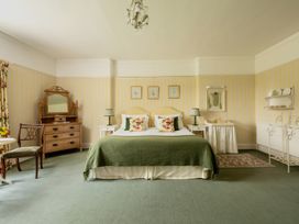 A bedroom with a bed and dresser at Parnacott in Holsworthy