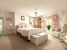 A bedroom with a bed and wardrobe at Parnacott in Holsworthy