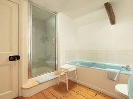 A bathroom with a shower and bathtub at Parnacott in Holsworthy