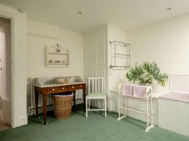 A bathroom with a wash basin and towel rack at Parnacott in Holsworthy