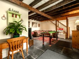 A snug with a pool table and sofa at Parnacott in Holsworthy