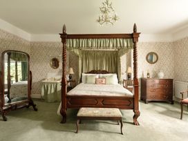 A bedroom with a four-poster bed and furniture at Parnacott in Holsworthy