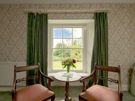 A seating area with two chairs and a table by a window at Parnacott Holsworth