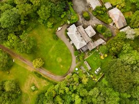 An aerial view of a property surrounded by trees and a pathway at Parnacott in Holsworthy