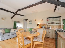 A kitchen with a dining area and seating at Tumrose Cottage in Blisland