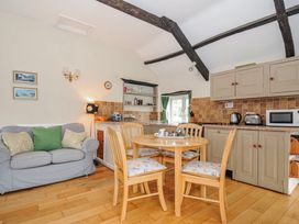 A kitchen with a table and chairs at Tumrose Cottage in Blisland