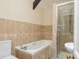 A bathroom with a bathtub, shower, toilet and sink at Tumrose Cottage in Blisland