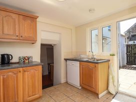 A kitchen with cabinets and appliances at Agar Cottage, Trelights, near Port Isaac