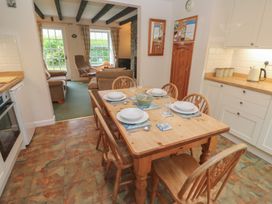 A dining room with a table set for meals at Primrose Cottage Edmonton, near Wadebridge