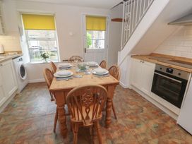 A dining room with a table and chairs at Primrose Cottage, Edmonton, near Wadebridge