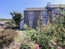 A building with windows and flowers in the garden at Atlantic View in Tintagel