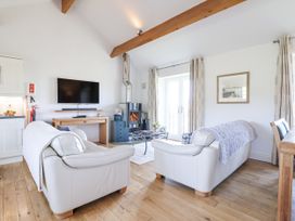 A living room with a sofa and coffee table at Atlantic View in Tintagel