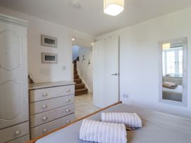 A bedroom with towels on the bed at Atlantic View in Tintagel