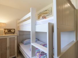 A bedroom with a bunk bed and cabinet at Atlantic View in Tintagel