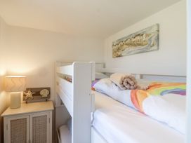 A bedroom with a bunk bed and lamp at Atlantic View in Tintagel