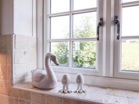 A kitchen window with a decorative swan and eggs at Atlantic View in Tintagel