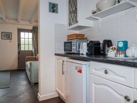 A kitchen with various appliances and countertop items at Kingfisher Cottage, Edmonton, near Wadebridge