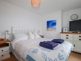 A bedroom with a bed and television at Kingfisher Cottage, Edmonton, near Wadebridge
