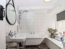A bathroom with a bathtub, sink, and shower at Cousham Cottage Kingsand And Cawsand