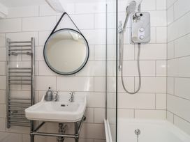 A bathroom with a sink and shower at Cousham Cottage in Kingsand And Cawsand