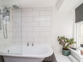 A bathroom with a bathtub and shower at Cousham Cottage in Kingsand And Cawsand