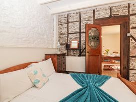 A bedroom with a bed and a door at Tregonhawke Farmhouse in Millbrook