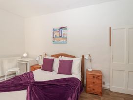 A bedroom with a bed and desk at Tregonhawke Farmhouse in Millbrook