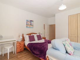 A bedroom with a bed and a desk at Tregonhawke Farmhouse in Millbrook