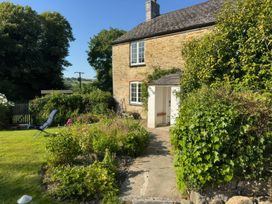 A garden view with a pathway and seating area at Kingbarth in Lerryn