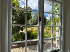 A view from a window showing a garden with plants and grass at Kingbarth in Lerryn