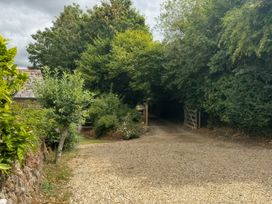 A path leading to a gate surrounded by trees and bushes at Kingbarth in Lerryn