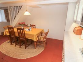 A dining room with a table and chairs at Mural Cottage in Mousehole