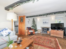 A living room with a christmas tree and fireplace at Clamoak Cottage in Clamoak near Bere Alston