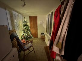 An entrance with a Christmas tree and a chair at Clamoak Cottage Clamoak near Bere Alston