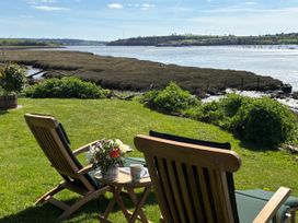 A garden with deck chairs and a flower arrangement at Clamoak Cottage Clamoak near Bere Alston