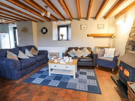 A living room with sofas and a coffee table at Old Farmhouse Cottage