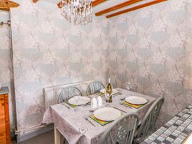 A dining room with a table set for meals at Old Farmhouse Cottage