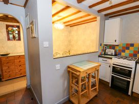 A kitchen with a stove and cabinetry at Old Farmhouse Cottage