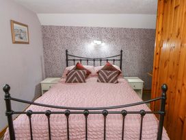 A bedroom with a bed and bedside table at Old Farmhouse Cottage