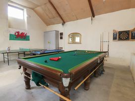 A recreational room with a pool table and darts board at Coetsiws in Clynnog Fawr