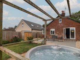 An outdoor area with a hot tub and seating at Sunny Croft Broadmayne near Dorchester