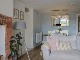 A living room with a sofa and dining area at Sunny Croft in Broadmayne near Dorchester