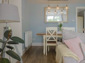 A dining room with a table and chairs at Sunny Croft in Broadmayne near Dorchester