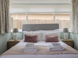 A bedroom with a bed and lamps on bedside tables at Sunny Croft in Broadmayne near Dorchester