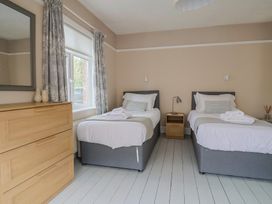 A bedroom with two beds and a window at Sunny Croft in Broadmayne near Dorchester