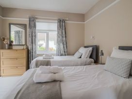 A bedroom with two beds and a dresser at Sunny Croft in Broadmayne near Dorchester
