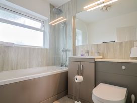A bathroom with a shower and bathtub at Sunny Croft in Broadmayne near Dorchester