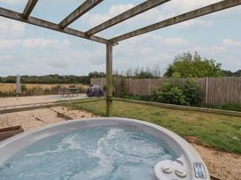 A garden with a hot tub and outdoor seating at Sunny Croft in Broadmayne near Dorchester