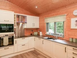 A kitchen with cabinets, sink, and appliances at Oak Lodge Pennington near Ulverston